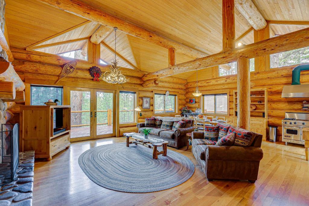 a large living room with wooden ceilings and a fireplace at Bend Getaway with Private Hot Tub and Cozy Fireplace in Bend