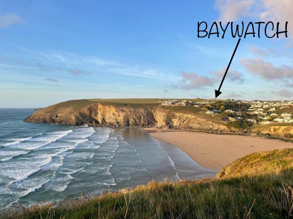 a picture of a beach with the words baywatch at Baywatch Mawgan Porth Spacious Home sleeps 9, Games room, Parking & Garden in Mawgan Porth