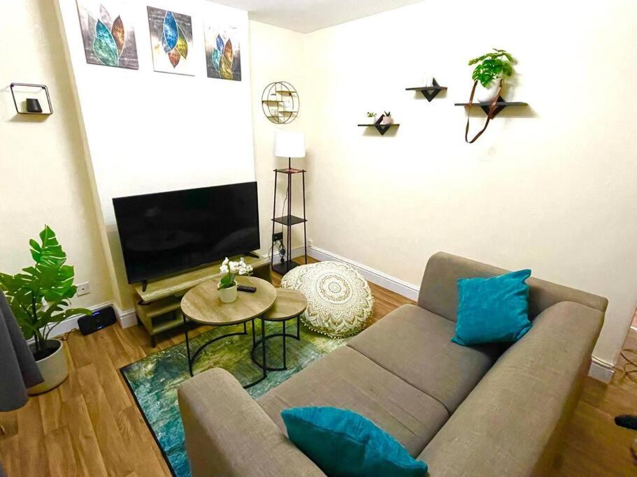 a living room with a couch and a flat screen tv at Charter House with good Wifi in Chatham