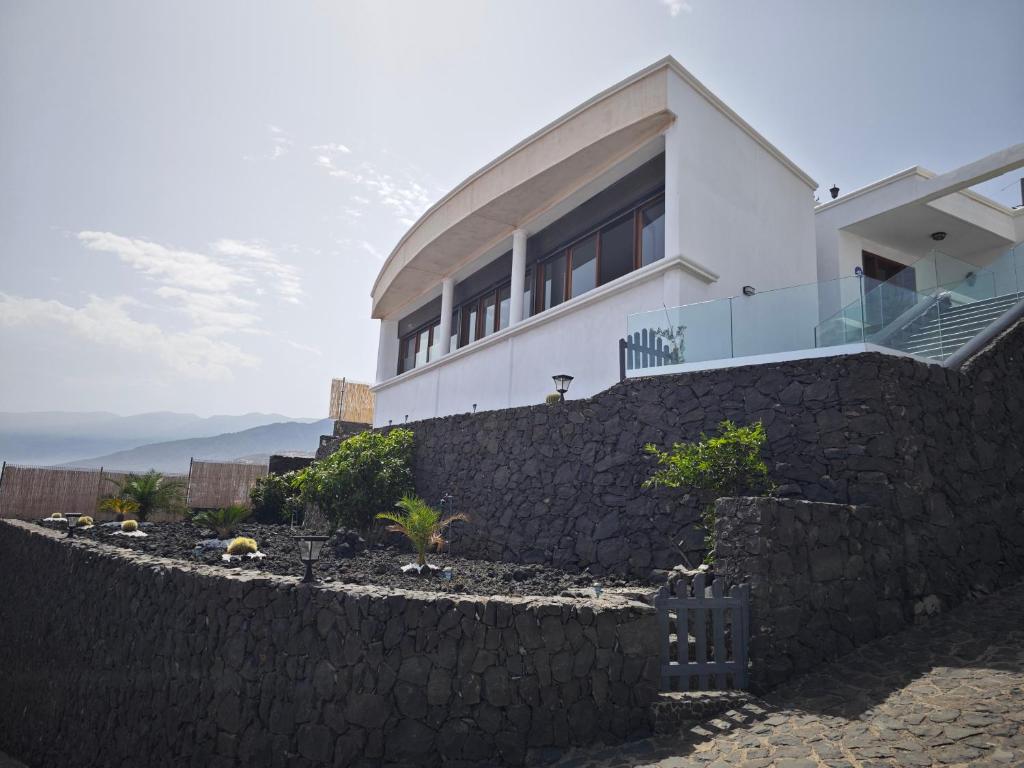 ein Haus auf einer Steinmauer in der Unterkunft Villa compartida Gonzalez in Radazul