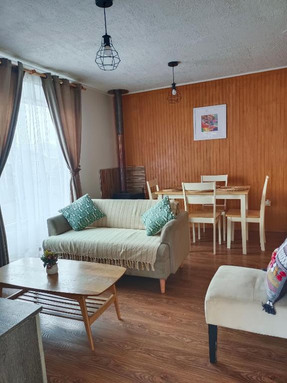 sala de estar con sofá y mesa en CASA EQUIPADA LAGO RANCO, en Lago Ranco