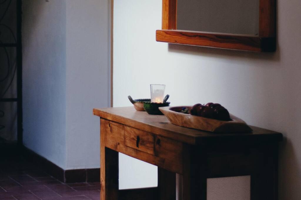 una mesa de madera con un bol de fruta. en Casa Nabani Oaxaca, en Oaxaca City