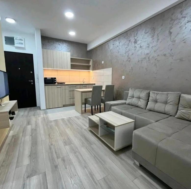 a living room with a couch and a table at cocoluxapartmanl73 in Trnava