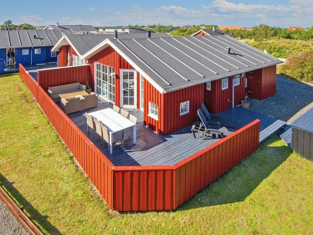 an overhead view of a red house with a deck at Holiday Home Anker II in Hvide Sande