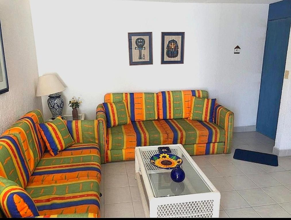 a living room with a couch and a coffee table at Departamento en Acapulco La Palapa in Acapulco