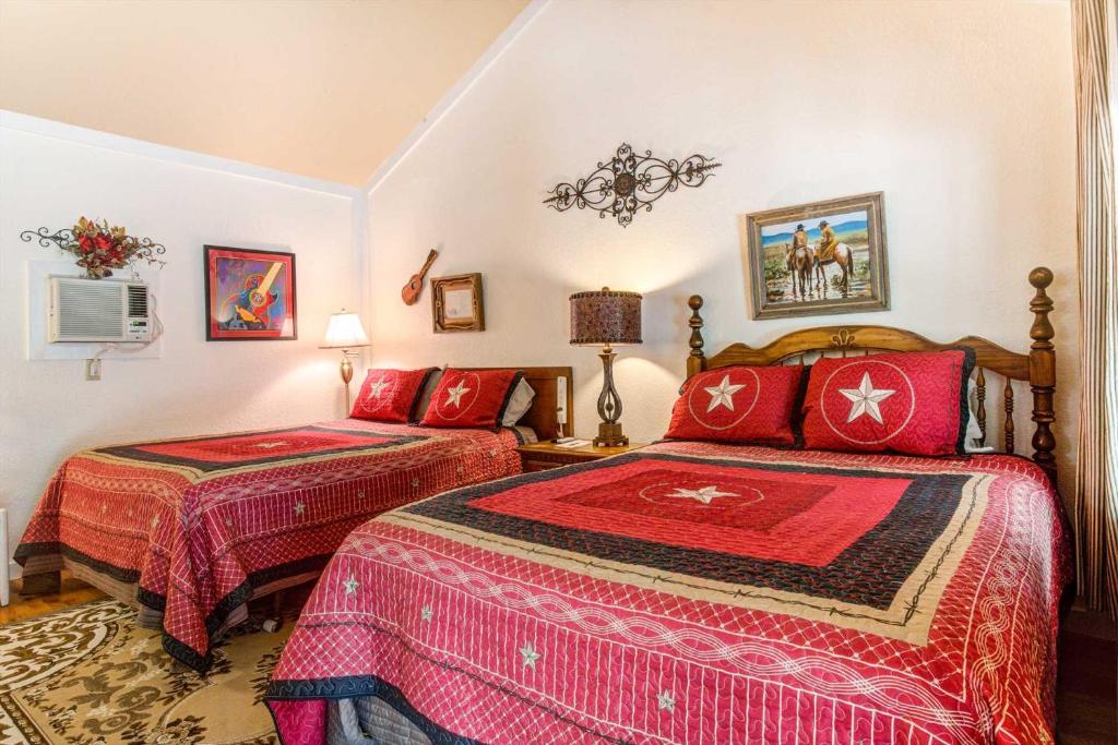 a bedroom with two beds and a couch at #2 Forge ~ Bandera Tin Star ~ Bandera, TX. in Bandera