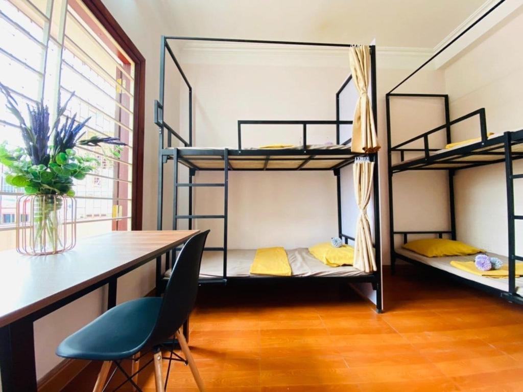a room with three bunk beds and a desk at 3BT home in Hanoi