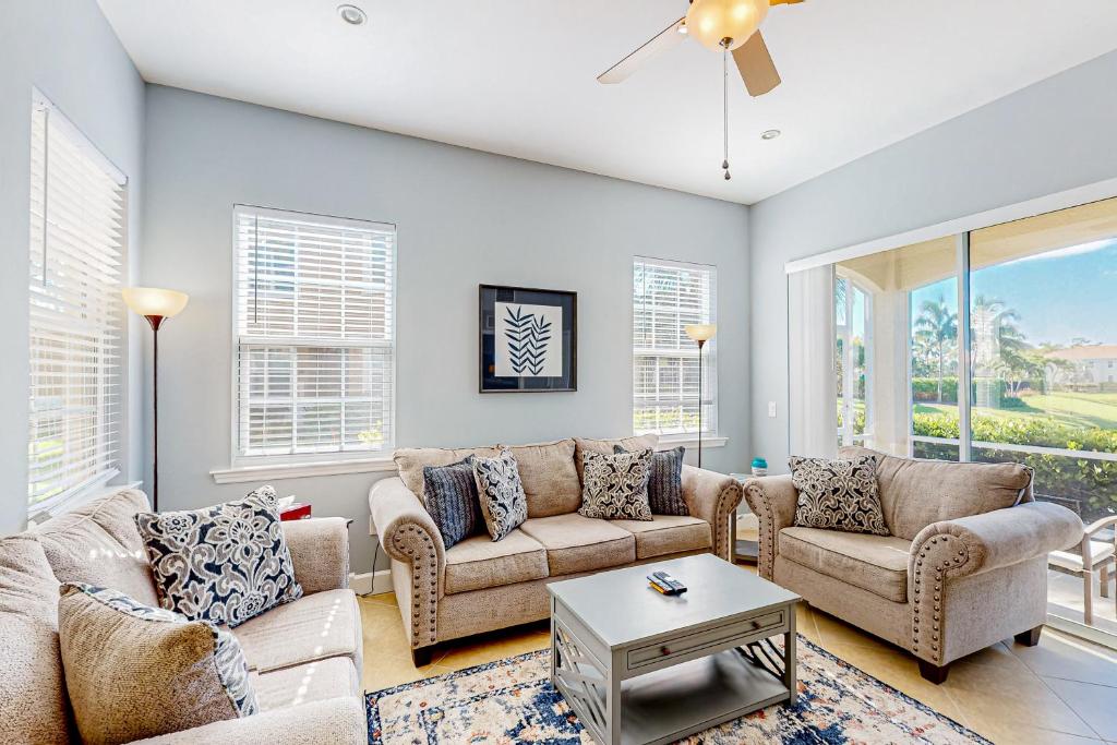 a living room with couches and a table at Paradise in Creekside Preserve in Fort Myers
