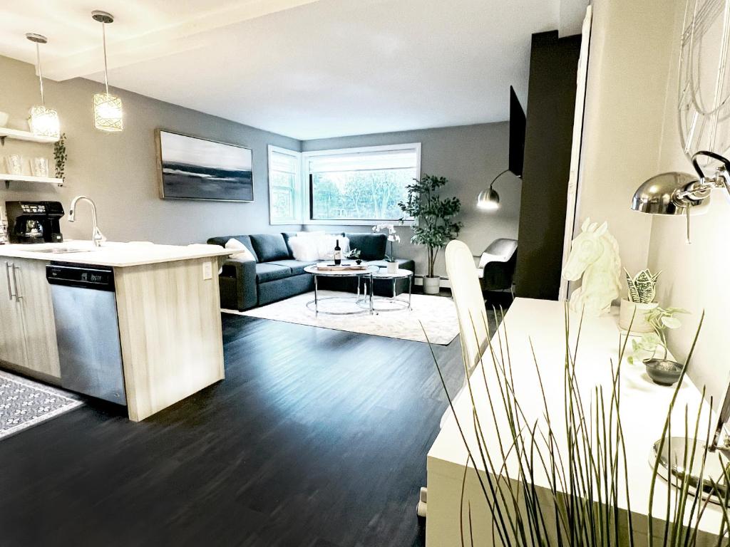 a kitchen and living room with a couch and a table at The Cosmopolitan in Wortley Village in London