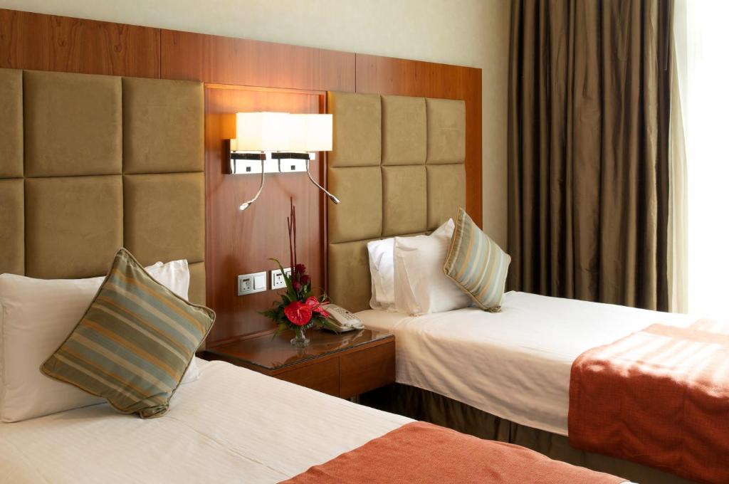 Postel nebo postele na pokoji v ubytování Montreal Barsha Hotel