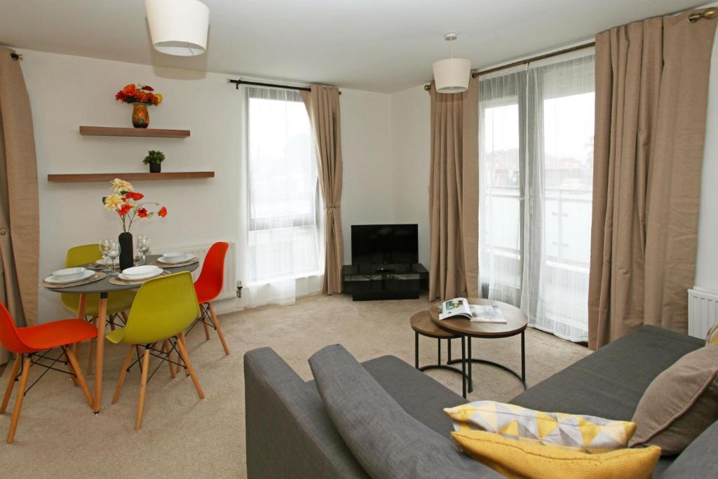 a living room with a couch and a table at Autumn Heights Apartments in Telford