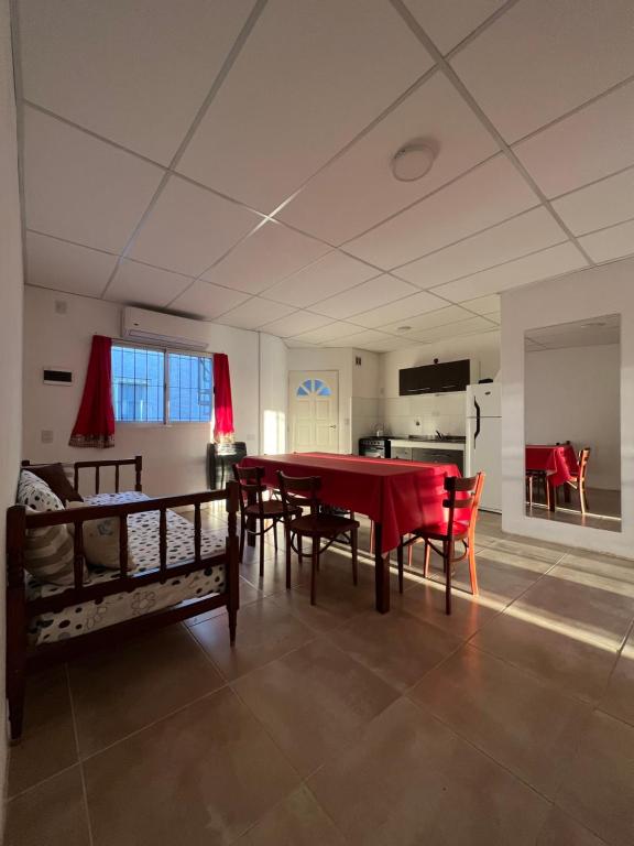a dining room with a red table and chairs at Delsa in Concordia
