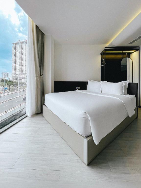 Postel nebo postele na pokoji v ubytování The Concept Hotel HCMC- District 1