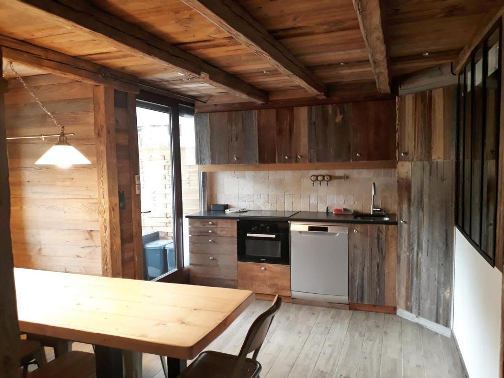 a kitchen with wooden walls and a wooden table at Appartement Morillon Village, 4 pièces, 7 personnes - FR-1-412-89 in Morillon