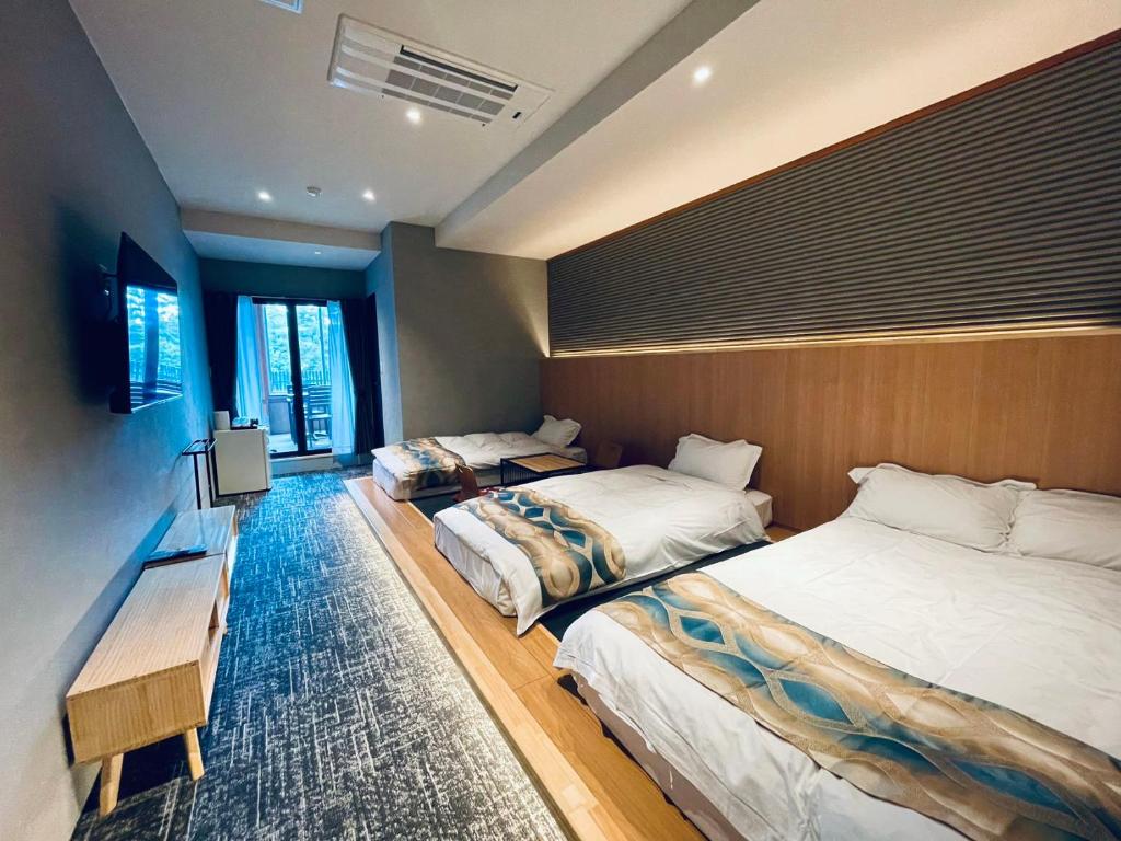Postel nebo postele na pokoji v ubytování Kurobe Sunvalley Hotel