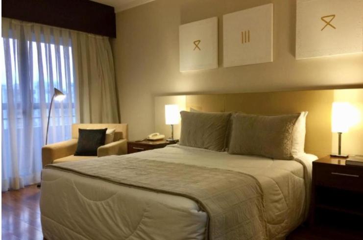 A bed or beds in a room at Grand Plaza Paulista Hotel