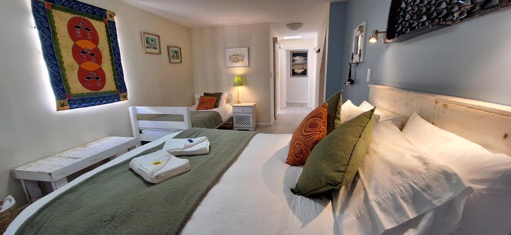 um quarto com uma cama grande e almofadas em Langebaan Paradise Beach Self Catering 5 Elara em Langebaan