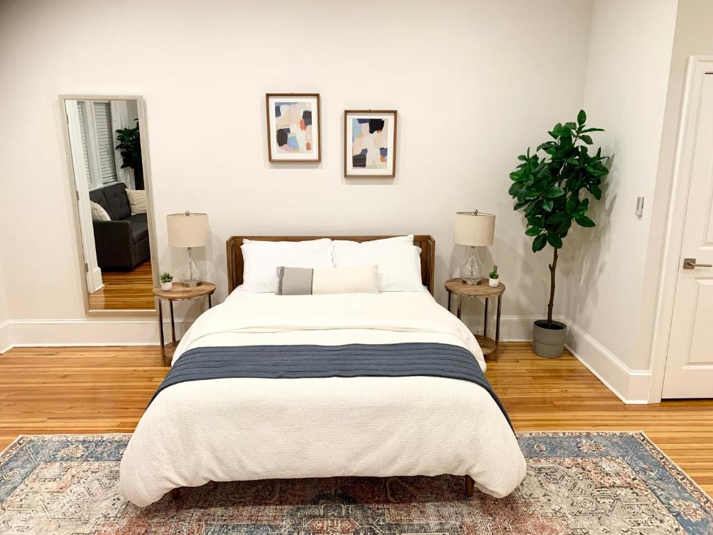a bedroom with a large bed with two end tables at Charming 1BD/1BA Studio; walk to stadiums & UMD in Baltimore