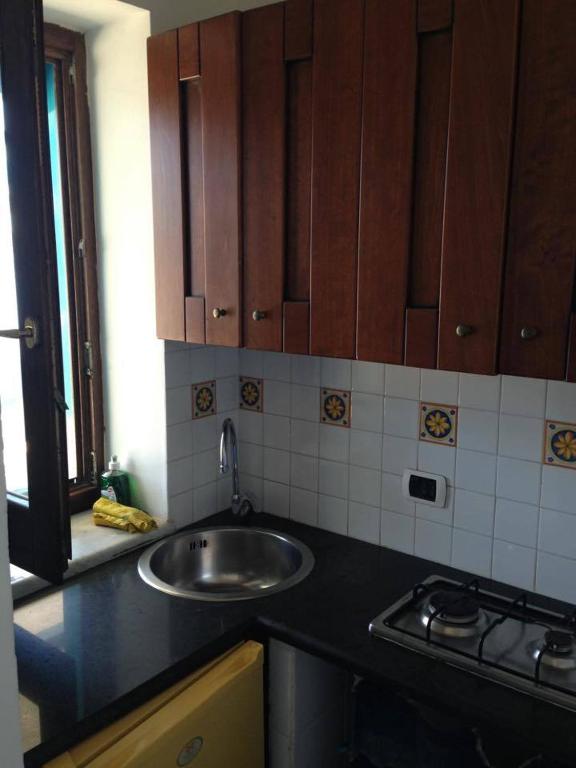 a kitchen with a sink and a counter top at Azzurromare Residence in Procida