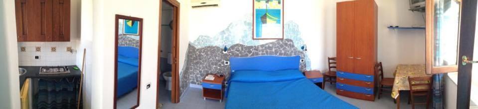 two views of a bedroom with a bed in it at Azzurromare Residence in Procida
