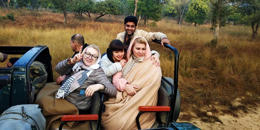 a group of people riding in the back of a truck at Hotel Maa Mira Villa in Khajurāho