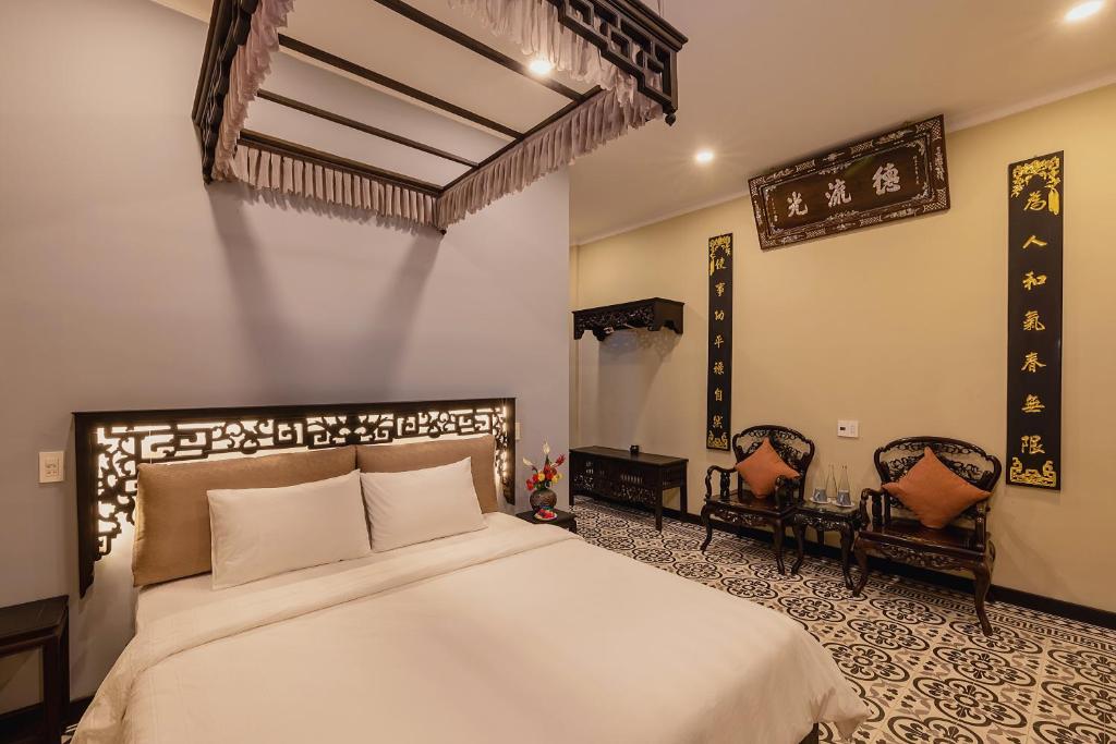 Giường trong phòng chung tại HueNam Residence
