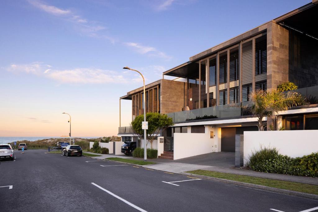 a street with a building on the side of a road at Luxury in Paradise - Sea views and Beach in Mount Maunganui