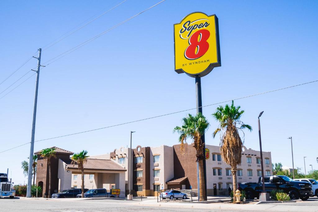 un panneau indiquant un restaurant de hamburgers dans un parking dans l'établissement Super 8 by Wyndham Yuma, à Yuma