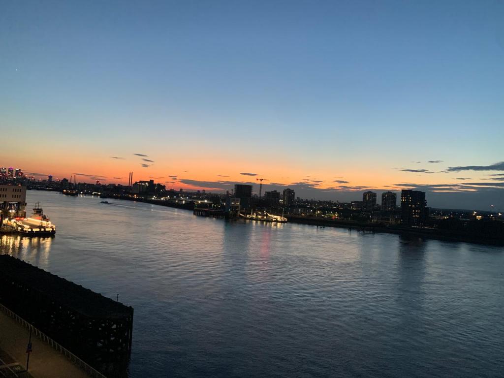 a view of a river with a city in the background at Luxury Riverside Apt with easy access to Central London, O2, Excel centre and Parking in Woolwich