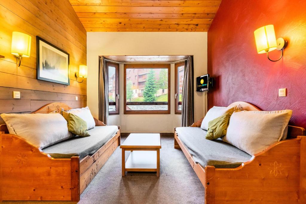 a living room with two couches and a table at Quartier La Forêt - maeva Home - Appartement 2 pièces 5 personnes - Sélection MAE-3904 in Valmorel