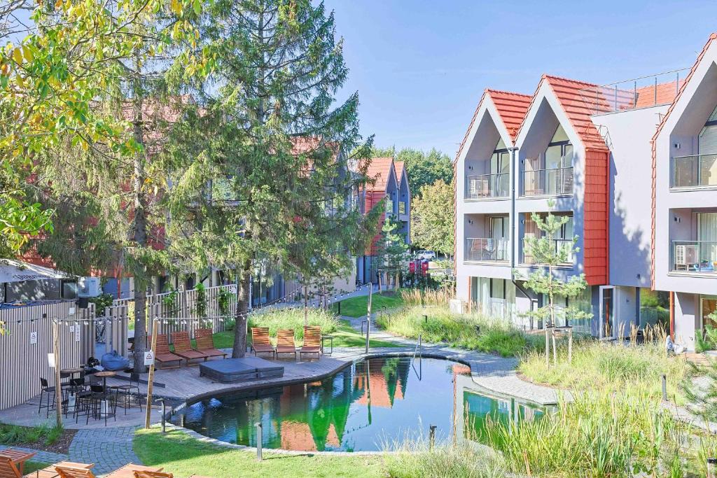 an apartment complex with a swimming pool in a city at Baltic Pine Retreat W/Balcony, By Cohost in Palanga