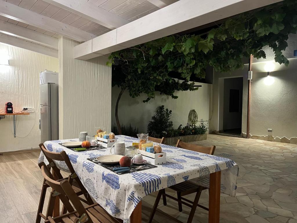 a table with a blue and white table cloth on it at TS ROOMS - Guest House Deidda in San Sperate