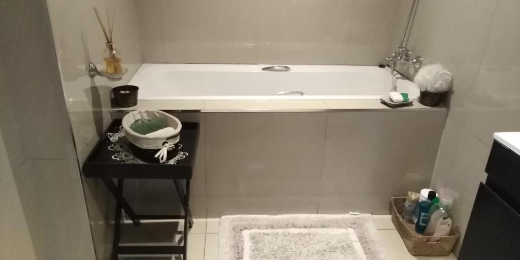 a small bathroom with a tub and a sink at VIP Deluxe Restroom Zone in Durban