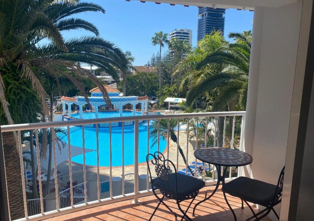 a balcony with a view of a swimming pool at Location Location Location - Broadbeach :) in Gold Coast