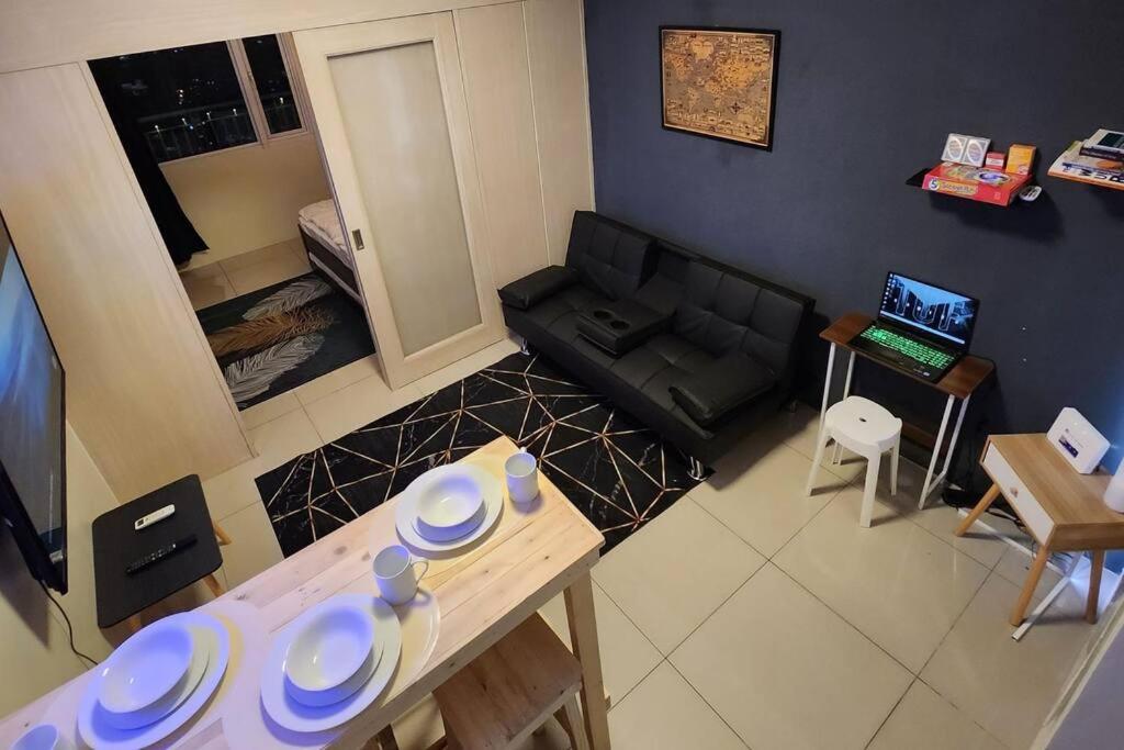 ein Wohnzimmer mit einem Sofa und einem Tisch in der Unterkunft Good Vibes Apartment in Makati in Manila