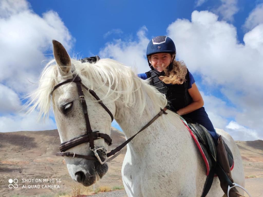 a woman riding on a white horse at Casa Barranco de la Sal in Puerto del Rosario