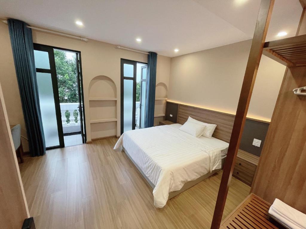 Postel nebo postele na pokoji v ubytování Mai An Hotel