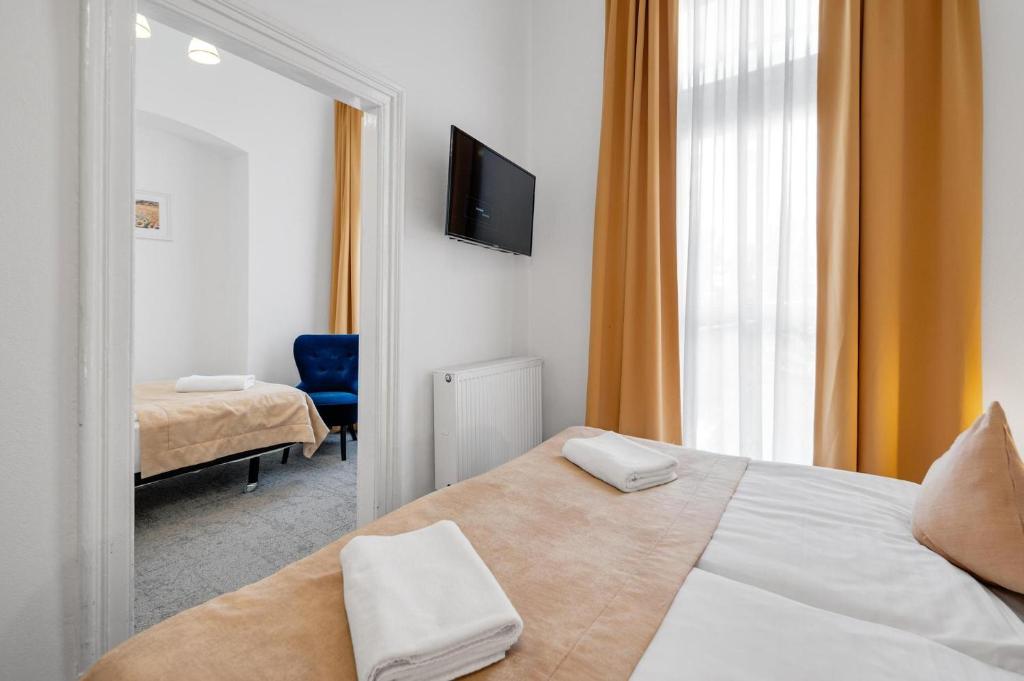 A bed or beds in a room at Downtown Bratislava B&B