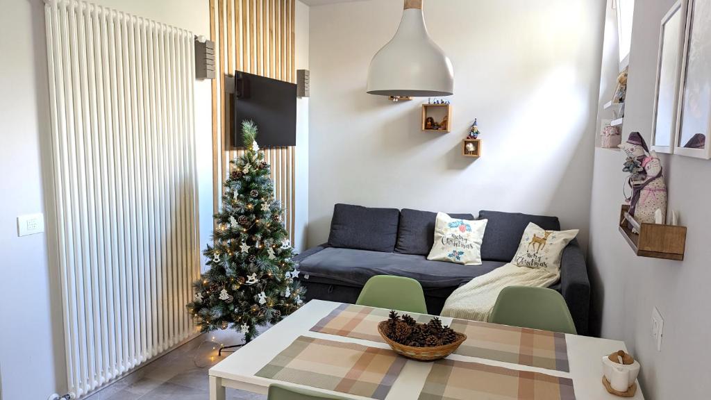 a living room with a christmas tree and a blue couch at ApartRiva in historical center near Lake in Riva del Garda