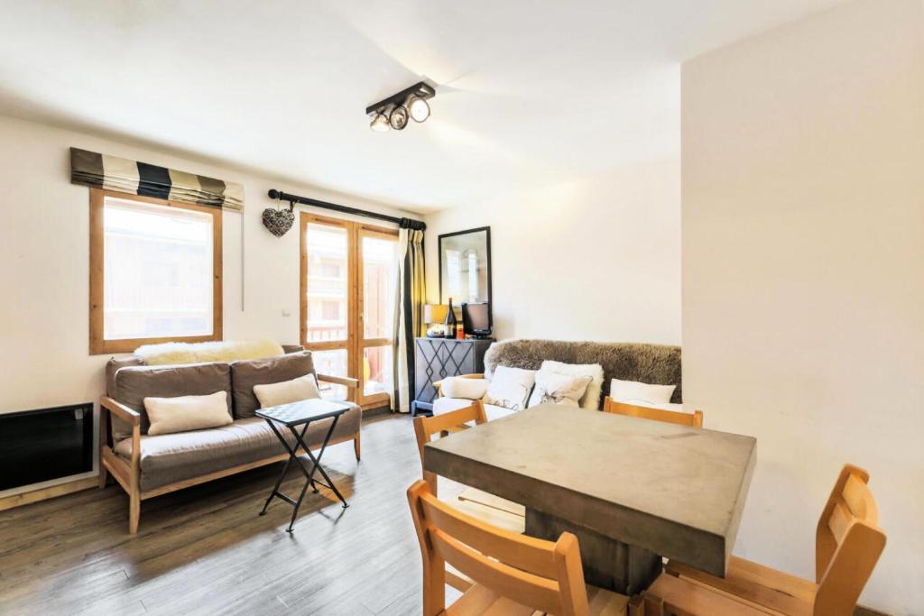 a living room with a table and a couch at Résidence Les Ravines - maeva Home - 2 pièces 4 personnes Sélection MAE-3913 in Les Allues