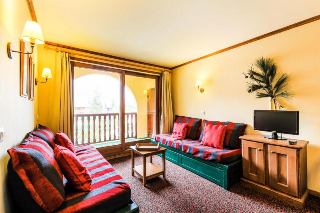 un salon avec deux canapés et une télévision dans l'établissement Résidence L'Alpaga - maeva Home - Appartement 2 pièces 5 personnes Confort MAE-1867, à La Salle Les Alpes