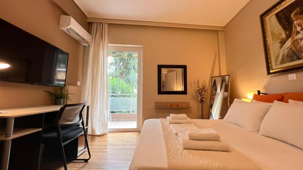 a bedroom with a bed and a desk and a window at Koukaki Cozy Studio Retreat 1' from metro in Athens