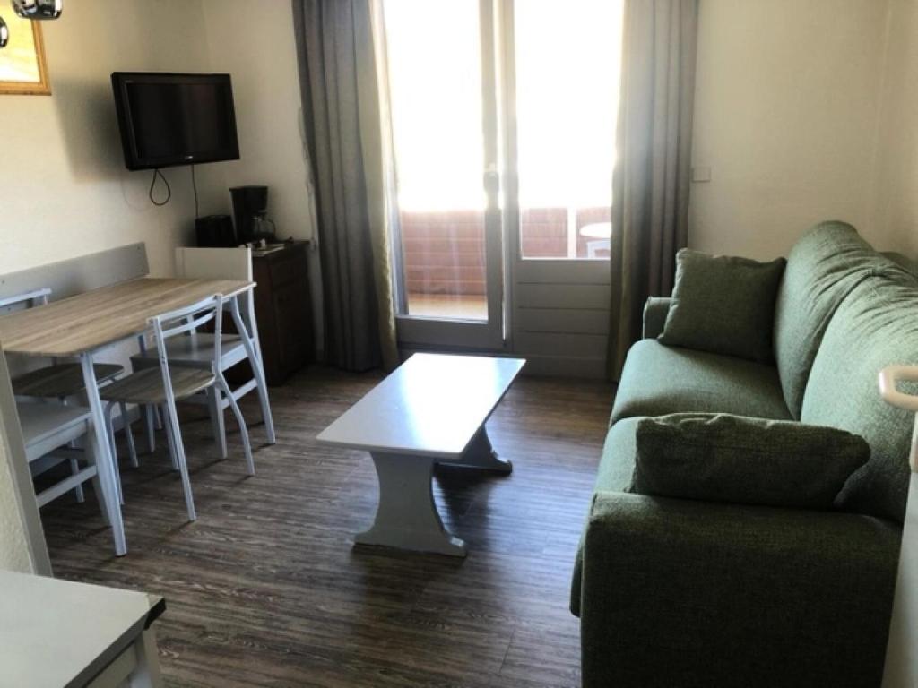 a living room with a couch and a table at Résidence Les Bergers - maeva Home - Studio 4 personnes - Sélection MAE-0234 in LʼHuez