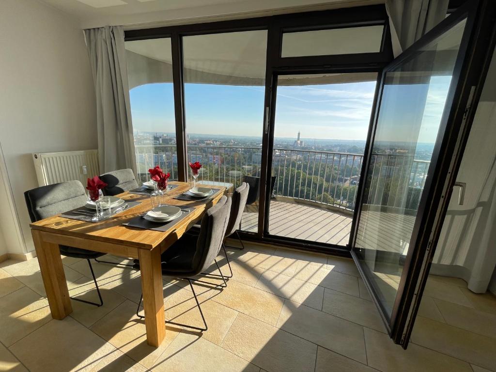 a dining room with a table and a view of the city at Augsburg Hotelturm in Augsburg