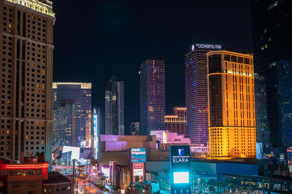 a city skyline at night with tall buildings at NO RESORT FEES-MGM StripView Adjoining Suites F1 View in Las Vegas