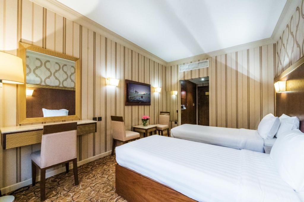 Postel nebo postele na pokoji v ubytování Dhiafat Al Raja Hotel