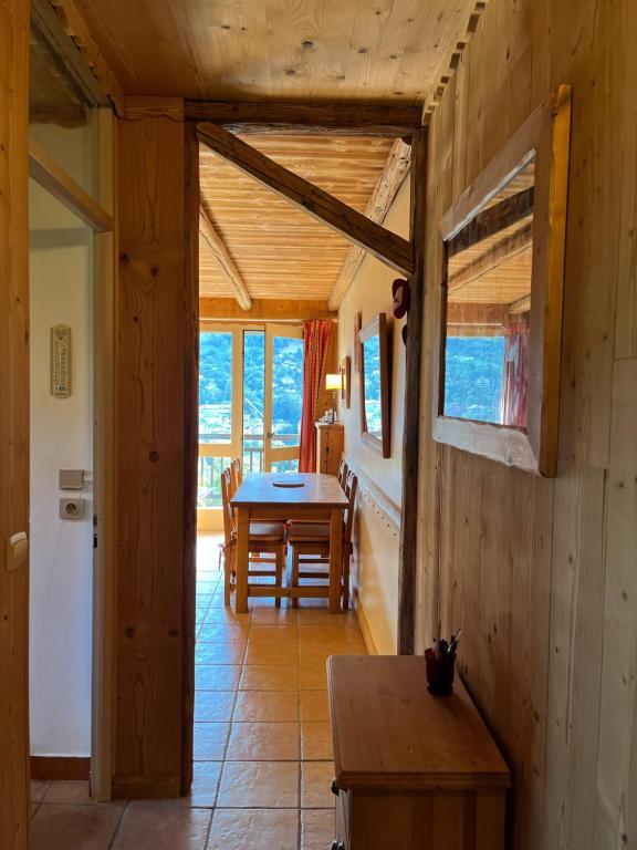 a wooden room with a table and a dining room at Appartement cosy, esprit chalet avec jolie vue in Saint-Gervais-les-Bains