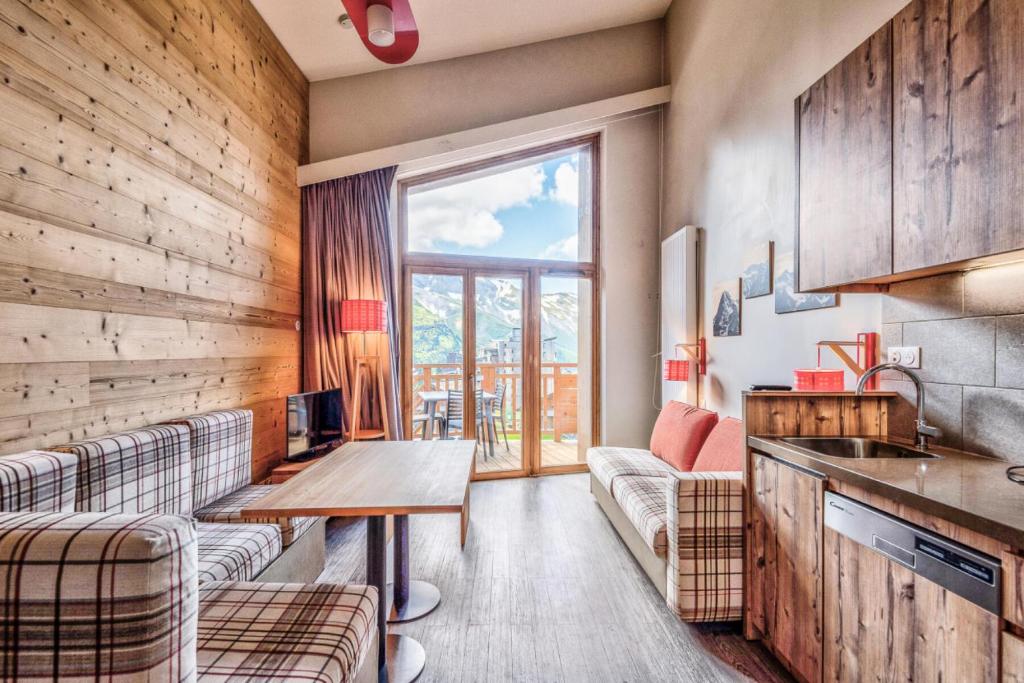 a living room with a table and two couches at Résidence Arietis - Atria-Crozats - maeva Home - Appartement 2 Pièces 5 Per 29 in Morzine