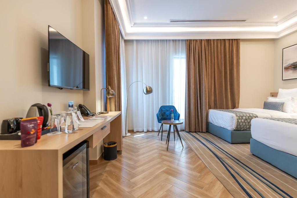 Postel nebo postele na pokoji v ubytování Marlo Hotel - فندق مارلو