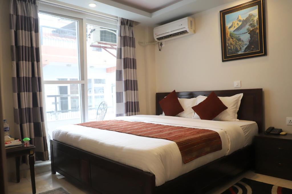 Postel nebo postele na pokoji v ubytování Hotel Pipal Tree